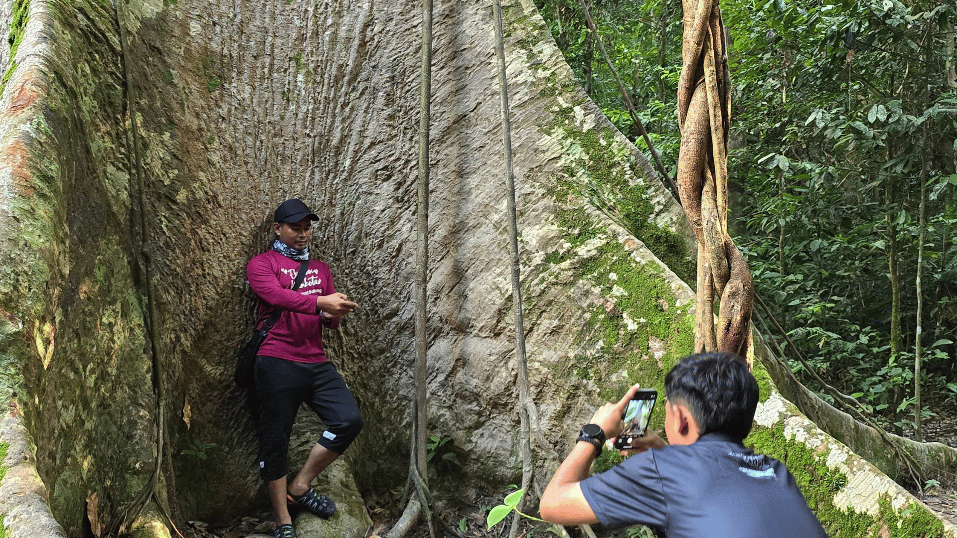 A participant applying the workshop lessons by capturing visual content in the forest environment during the Day 2 practical session.